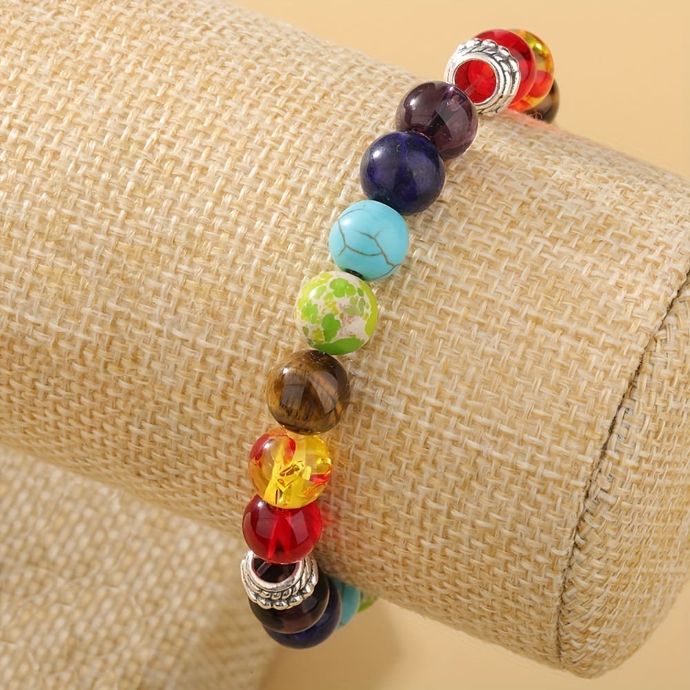 Elastic energy healing bracelet made with multicolored stones symbolizing seven chakra points