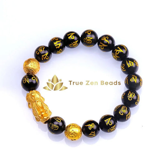 Close-up of Pixiu wealth bracelet showing engraved fortune beast and matte obsidian stones