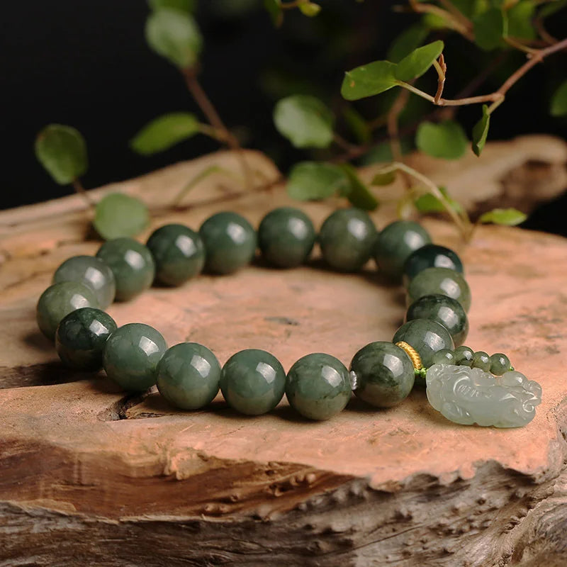Dark green jade bracelet with lucky Pixiu charm to attract money energy