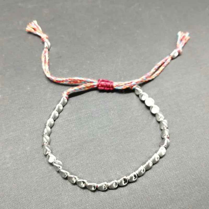 Tibetan monks blessing copper beads bracelet with mantra for luck and positive energy