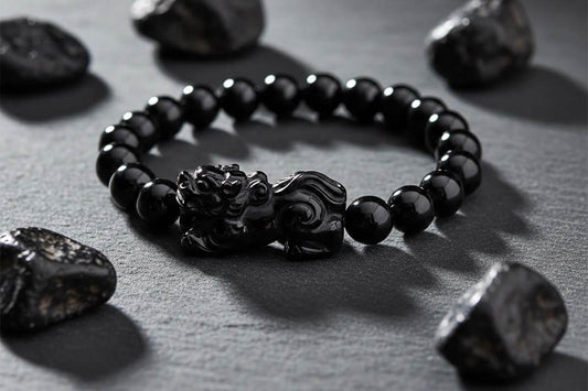 Featured image for black obsidian Pixiu bracelet guide showing volcanic glass beads with traditional Chinese mythological charm on dark surface