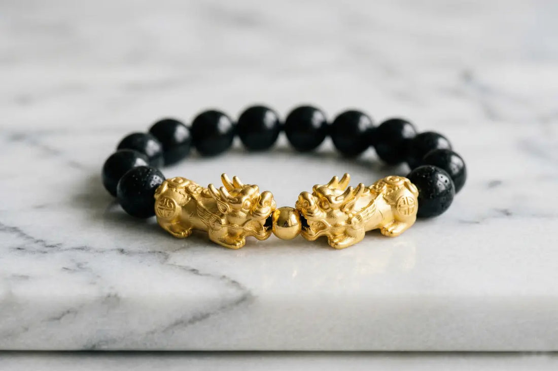 Double Pixiu bracelet featuring black obsidian beads and dual hand-carved mythological Pixiu charms, traditional Chinese cultural jewelry for artisan collection