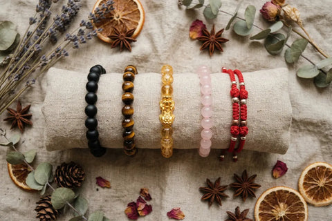 TrueZenBeads feng shui bracelet removal guide — obsidian, tiger eye, citrine and tibetan styles flat lay