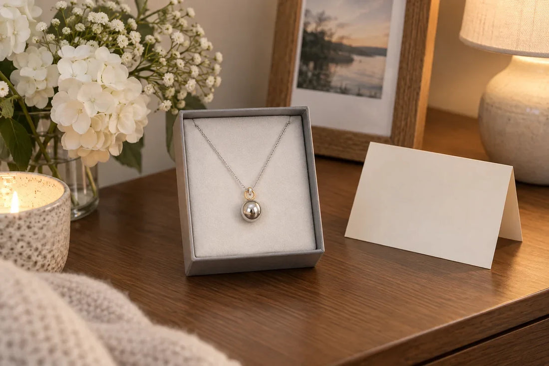 Memorial orb necklace styled as a quiet sympathy gift