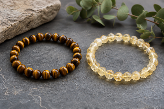 Tiger eye vs citrine comparison with a golden brown tiger eye bracelet beside a translucent yellow citrine bracelet