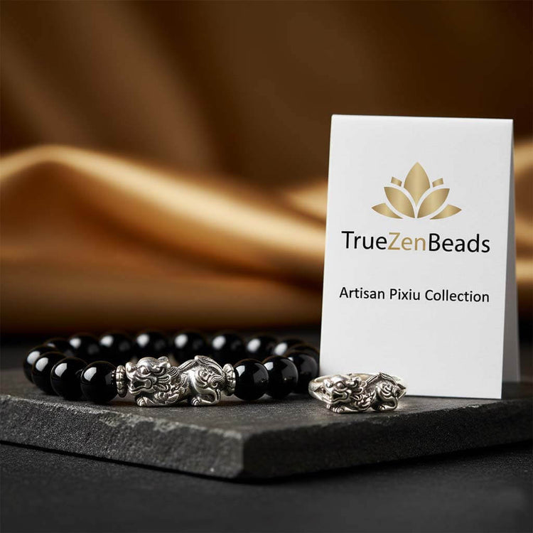 TrueZenBeads artisan Pixiu bracelet and ring featuring intricate metal carvings and natural black obsidian, displayed with a branded logo card.