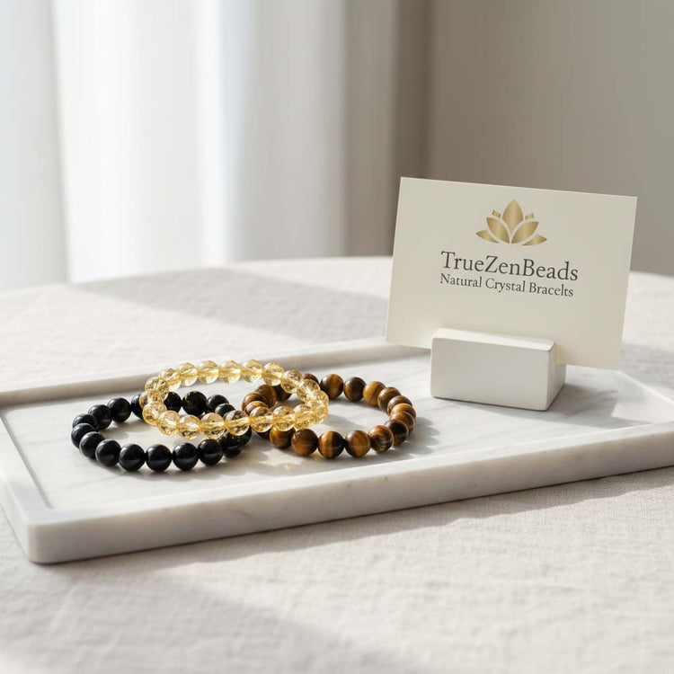 TrueZenBeads collection of handcrafted natural crystal bracelets featuring genuine obsidian, citrine, tiger eye, jade, rose quartz, and various premium gemstones, styled with a gold artisan lotus logo.