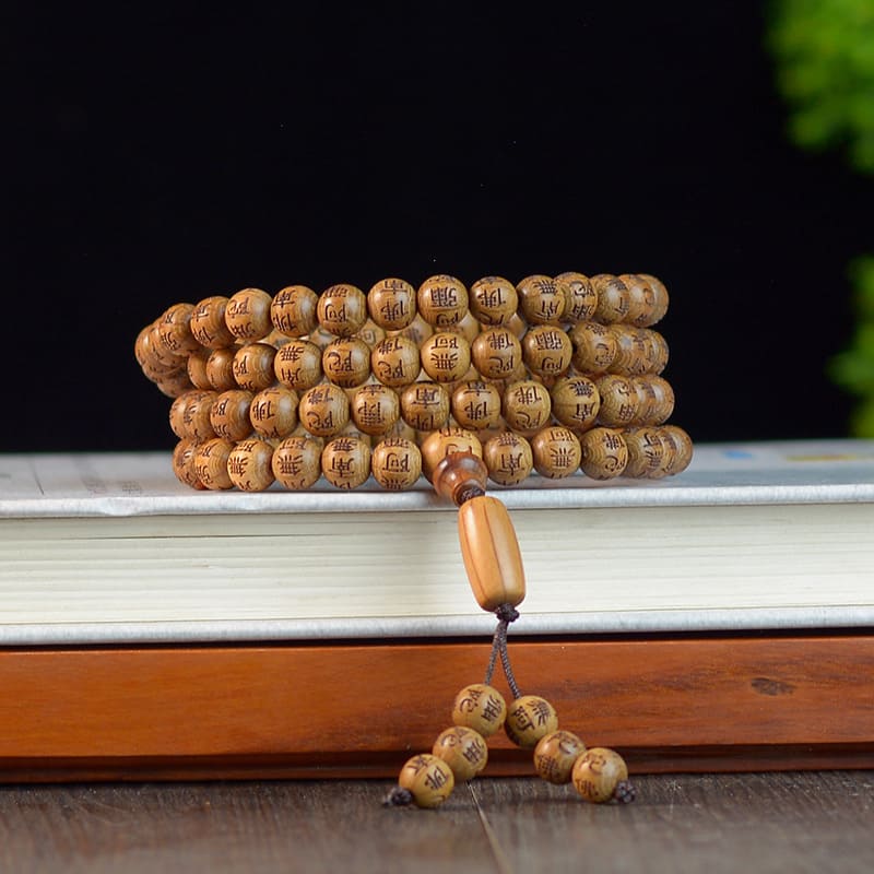 Spiritual practitioner using handcrafted mala beads during a peaceful outdoor meditation
