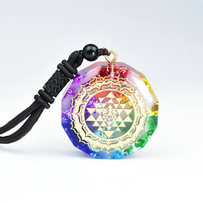 7 chakra orgonite resin necklace with golden Sri Yantra sacred geometry pattern and rainbow gradient