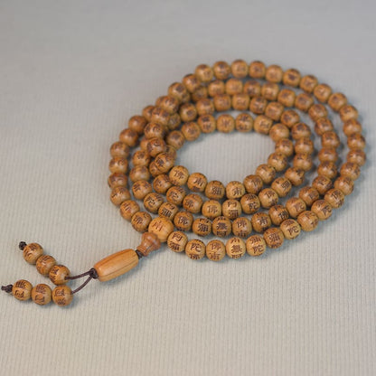 Detail shot of sacred mantra symbols etched into each handcrafted bead