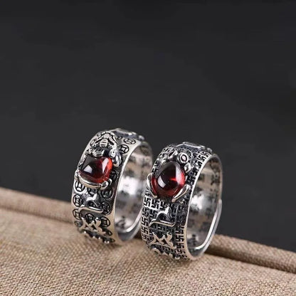 Feng Shui wealth ring with red garnet stone and lucky Chinese engravings