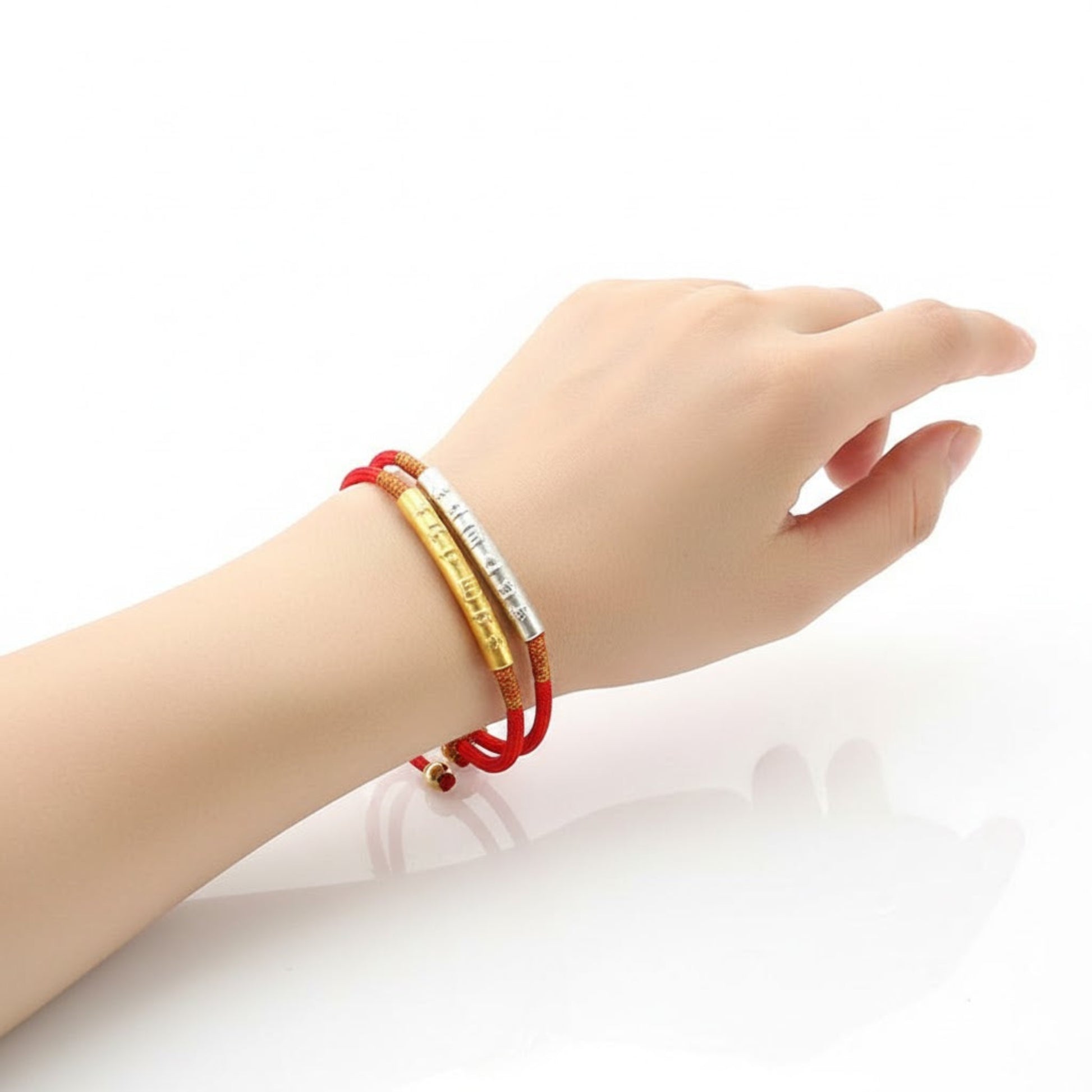 TrueZenBeads Tibetan red string bracelet featuring gold or silver mantra engraving, worn on wrist demonstrating mindfulness and calm