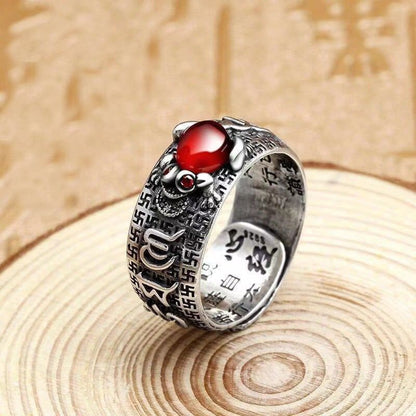 Adjustable garnet Pixiu ring showing Six Syllable Mantra and ancient coin engravings on metal band