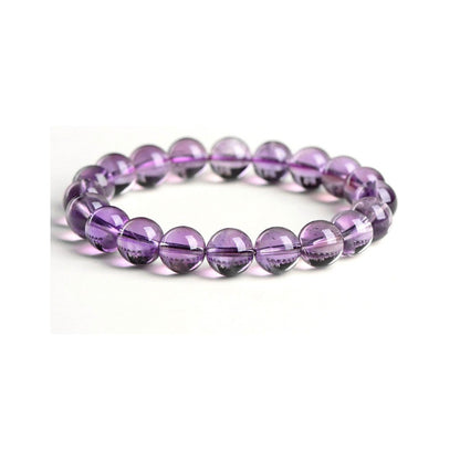 Close-up of polished amethyst crystal beads showing vitreous luster and natural inclusions