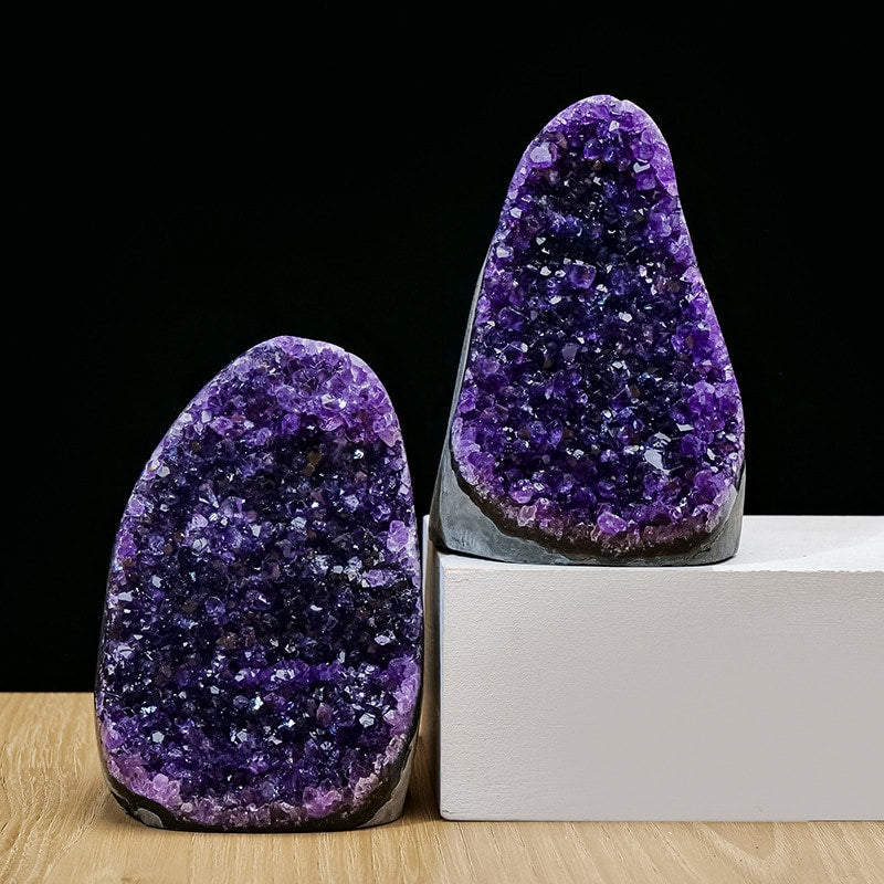 Amethyst geode pair display on black and white studio setup