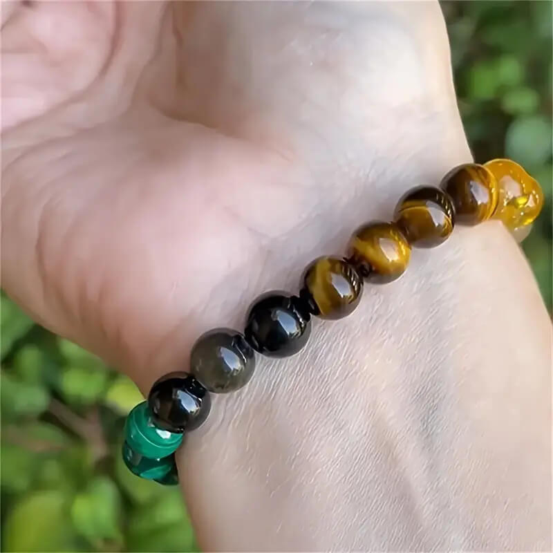 Person wearing a 7-color natural stone bead bracelet in a lifestyle setting showing the handcrafted design and colorful aesthetic.