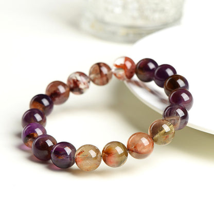 Auralite 23 Super Seven beaded bracelet on a light product background