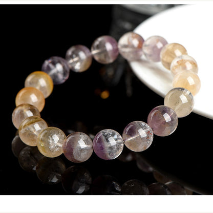 Auralite 23 Super Seven bracelet detail on a clean light background