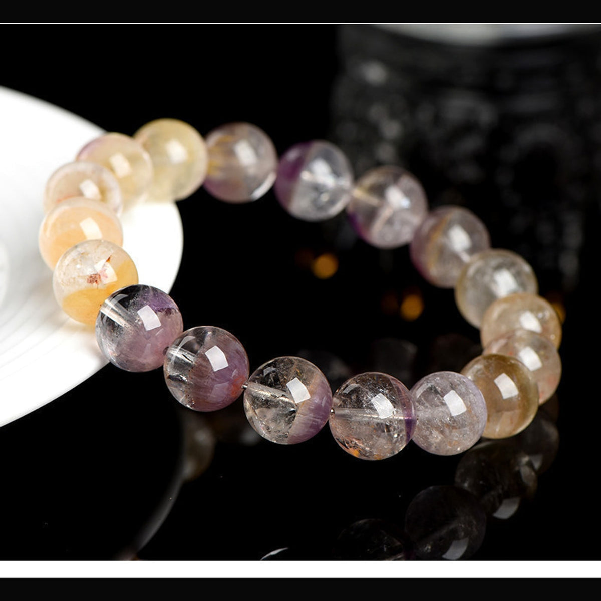 Round view of Auralite 23 Super Seven half basin bracelet on dark background