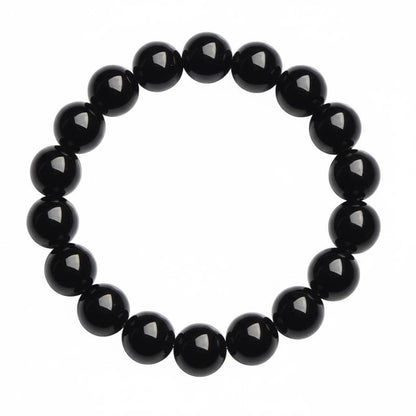 Black obsidian bracelet with polished mirror shine beads on white background - natural volcanic glass jewelry for men and women