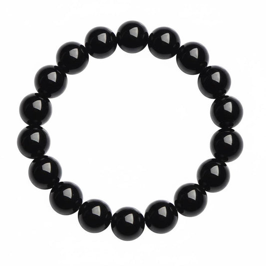 Black obsidian protection bracelet with polished mirror shine beads on white background - natural stone crystal for men and women