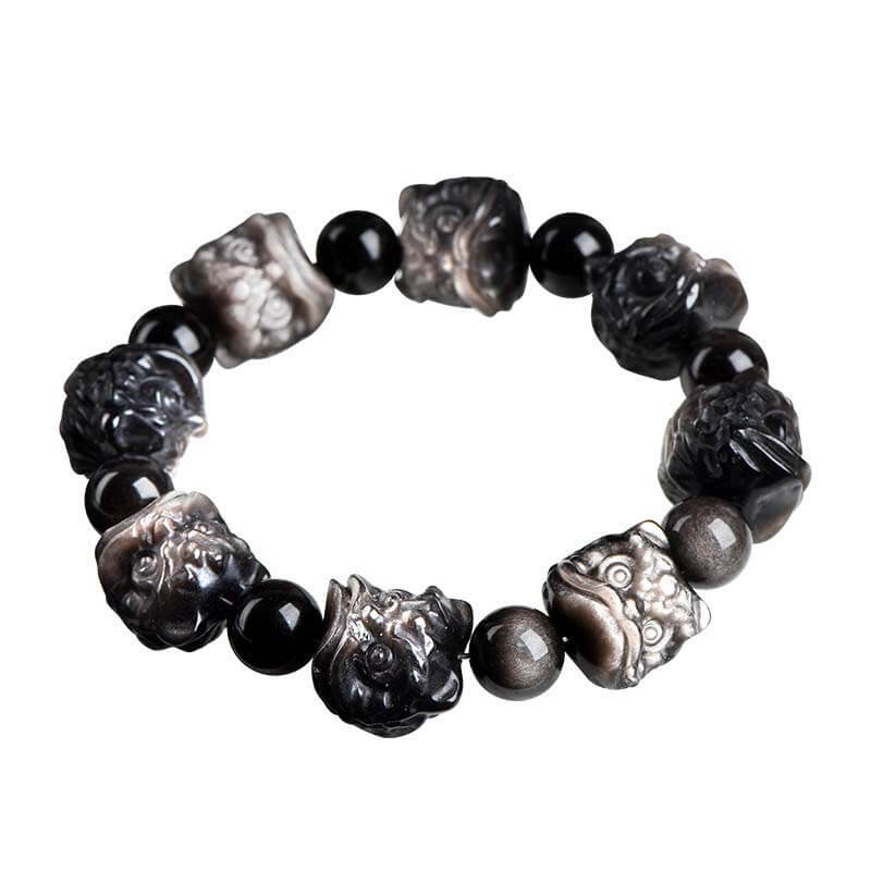 Black obsidian bracelet with silver lion Pixiu charms on white background