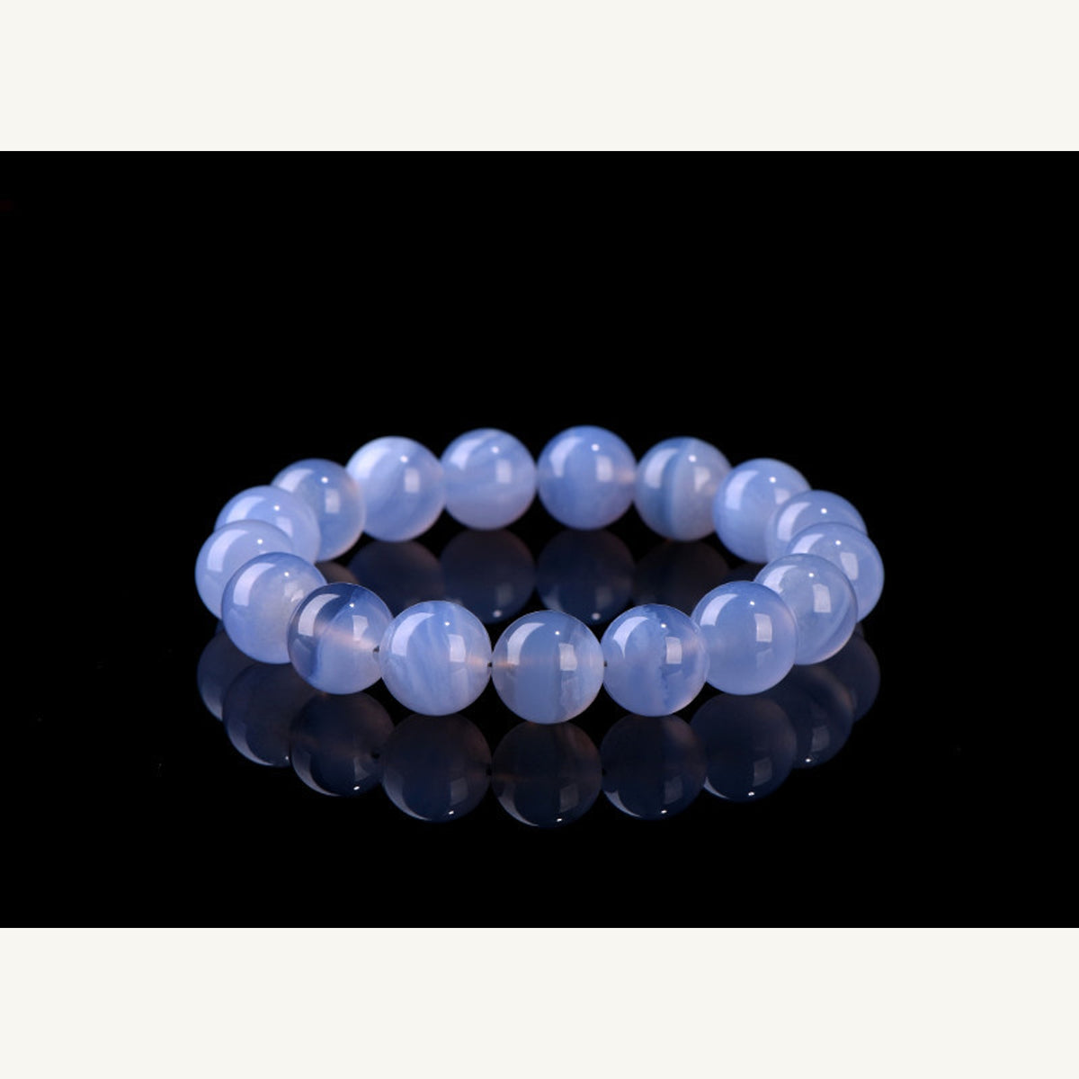 Blue agate bead bracelet on deep blue display background