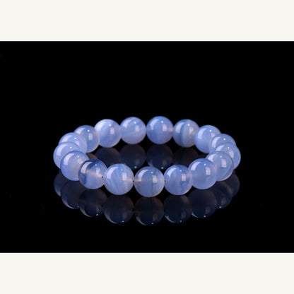 Blue agate bead bracelet on deep blue display background