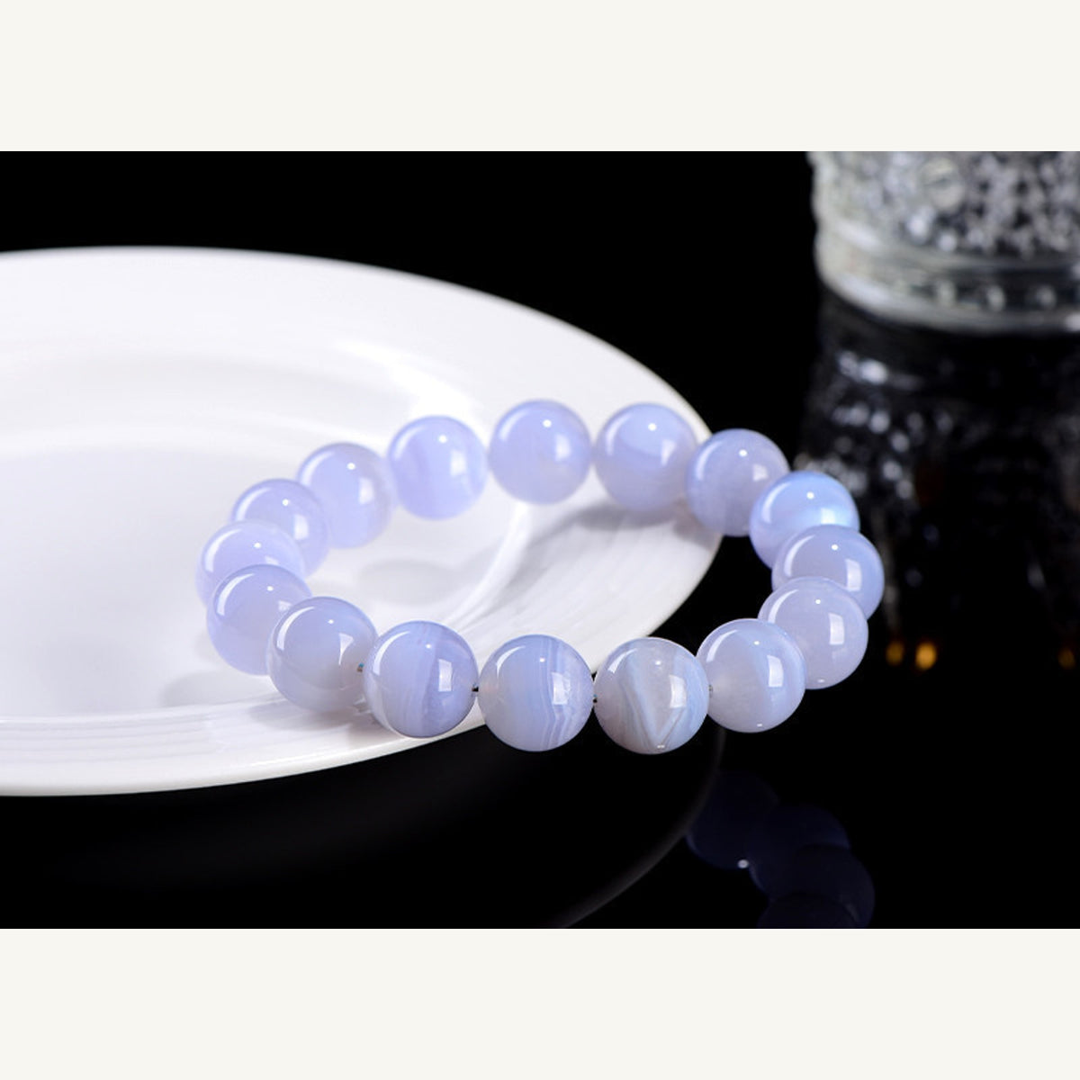 Blue agate round bead bracelet styled near a white dish