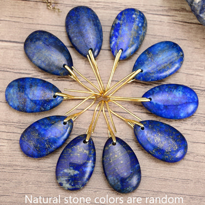 Close-up of blue lapis lazuli dangle earrings with polished natural stone texture
