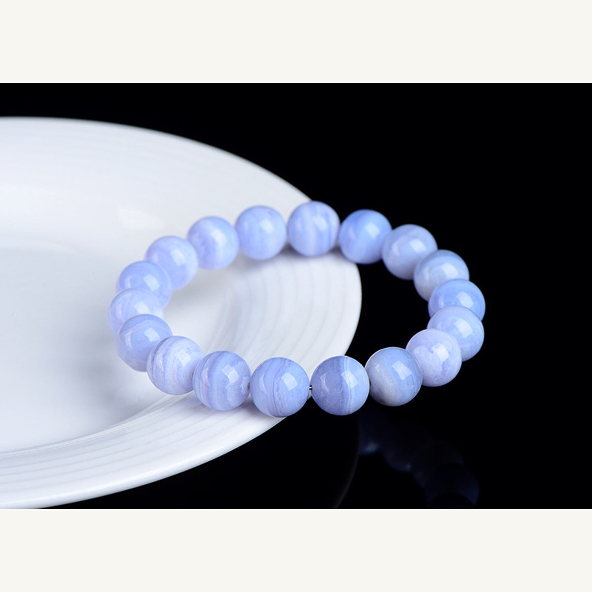 Blue striped agate bracelet on white plate display