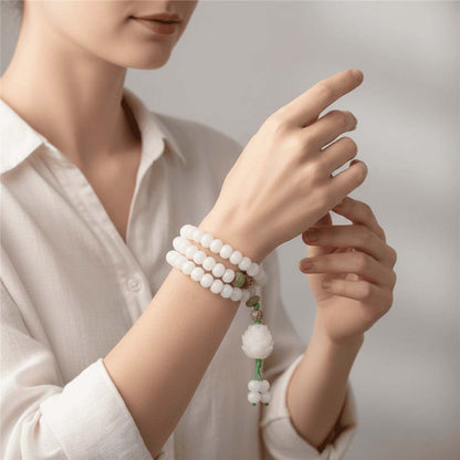 Person holding Bodhi Mala beads during meditation practice for mindfulness and mantra counting