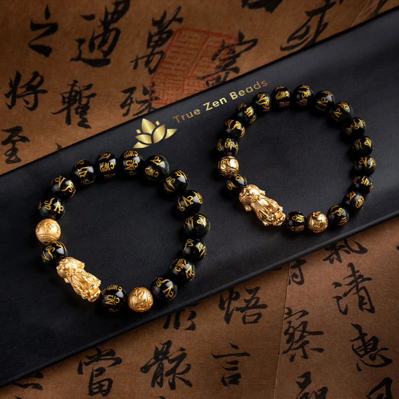 Black obsidian wealth bracelet on neutral background highlighting bead size and color depth