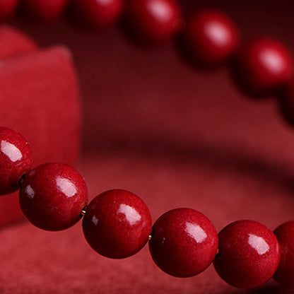 Cinnabar style red beaded stretch bracelet in 90 purple gold sand style