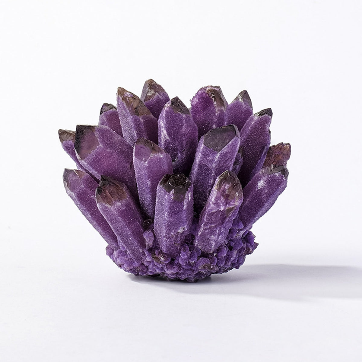 Deep purple amethyst crystal cluster decor on white background