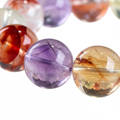 Close up garden quartz beads hand-polished vitreous luster phantom inclusions scenic patterns