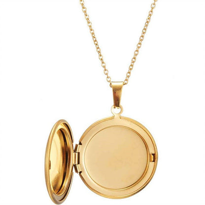 Gold round photo locket necklace opened to show blank photo compartment