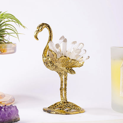 Gold swan with clear quartz crystal points in a home display