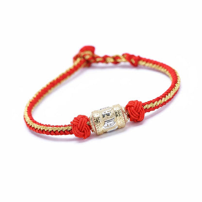 Handcrafted Tibetan red rope bracelet with prayer wheel cylinder and Six Syllable Mantra engraving