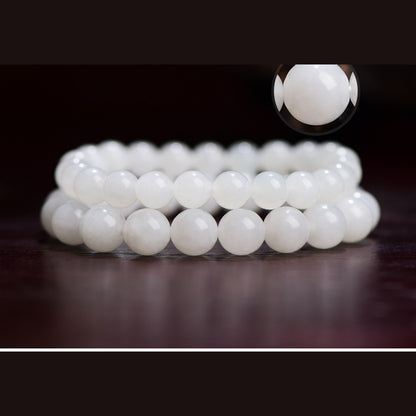 Close detail of polished Hetian white jade round bracelet beads