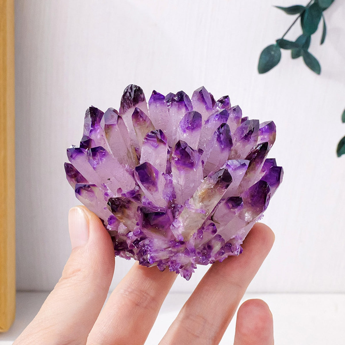 Light amethyst fine point crystal cluster held in hand