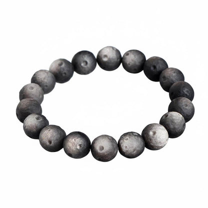 Matte black obsidian bracelet with smooth frosted finish on white background - affordable natural volcanic glass jewelry