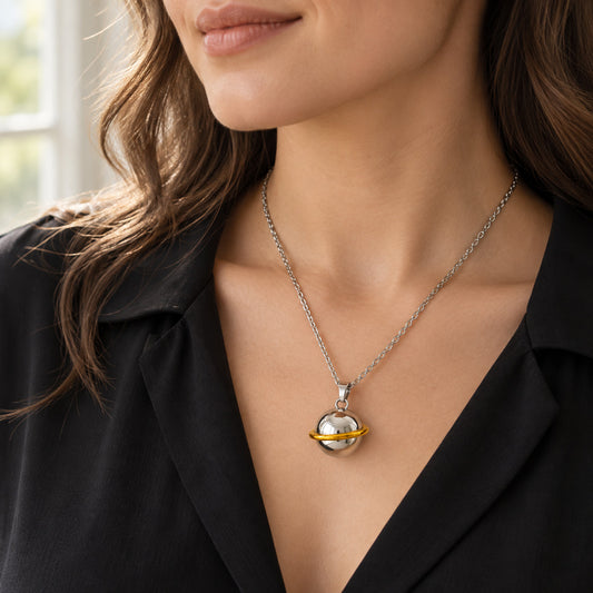 Stainless steel memorial orb necklace worn over a black blouse