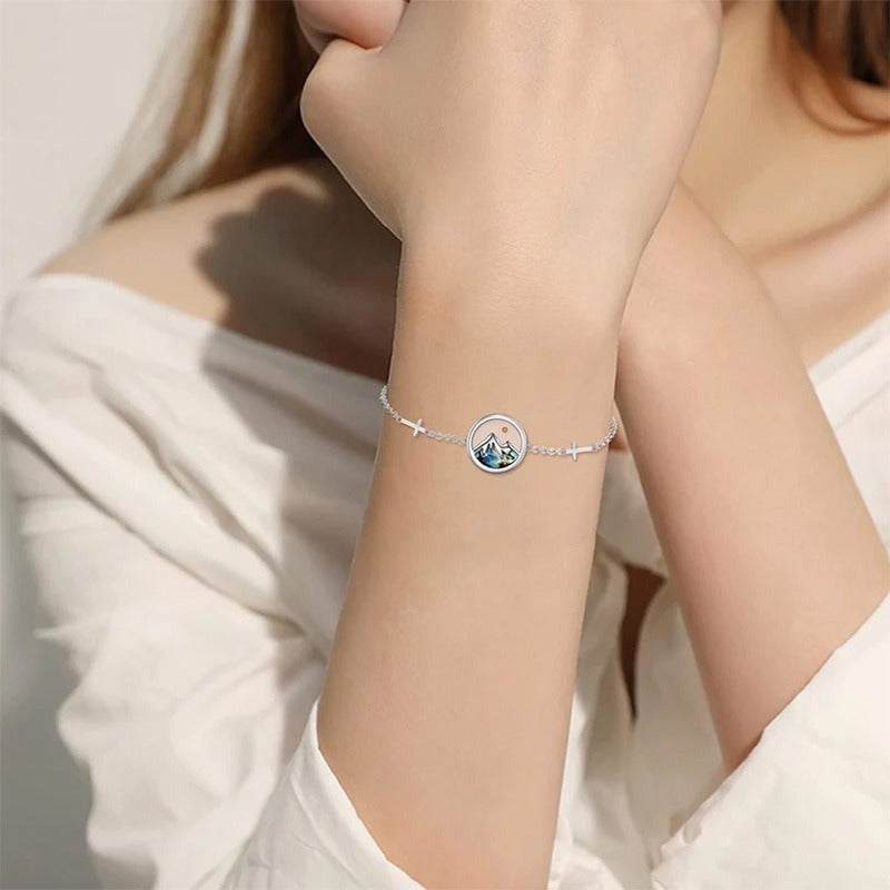 Mustard seed mountain bracelet worn on the wrist with a soft lifestyle look