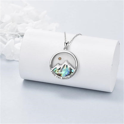 Mustard seed mountain pendant necklace displayed on a white jewelry roll