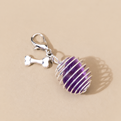 Close-up of tumbled amethyst pet charm with silver bone detail