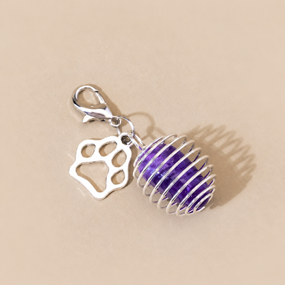Close-up of tumbled amethyst pet charm with silver paw detail