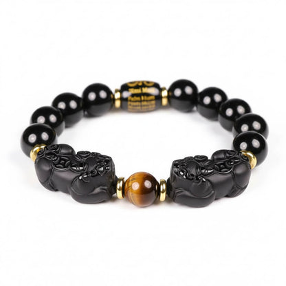 Natural Black Obsidian Bracelet with double Pixiu charms and tiger eye accent showing volcanic glass beads