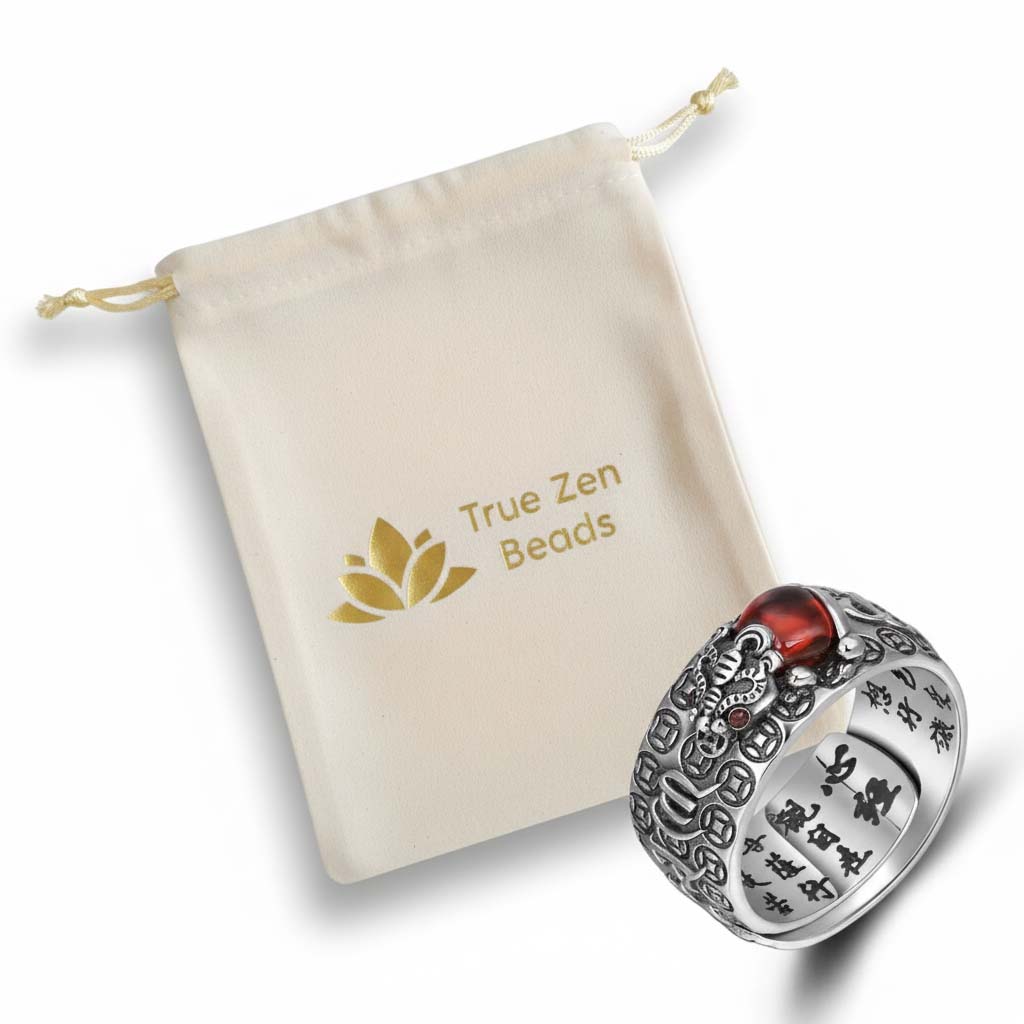 Natural garnet rings with hand-carved Pixiu and Golden Toad designs displayed in TrueZenBeads branded gift bag packaging with golden lotus logo - traditional cultural jewelry ready for gifting