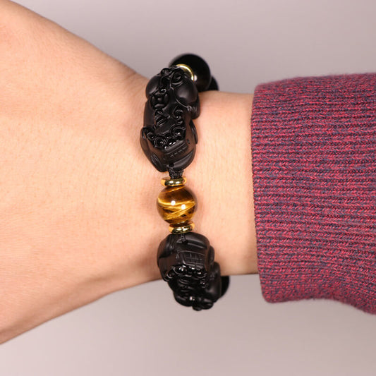 Person wearing Black Obsidian Pixiu Bracelet for Chinese cultural heritage and traditional symbolism